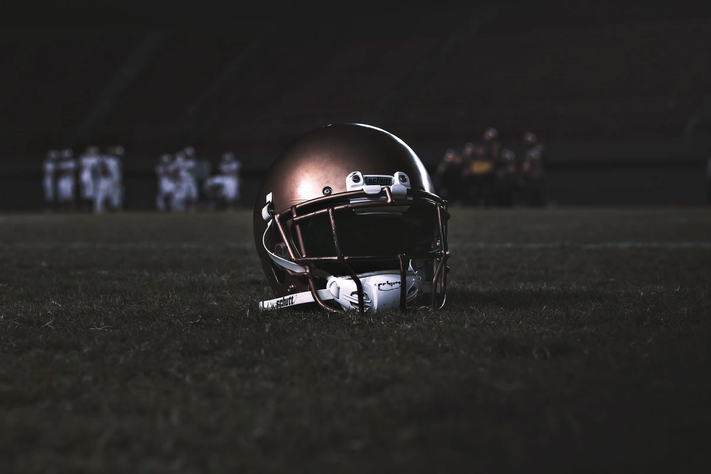 A football helmet on the field at night